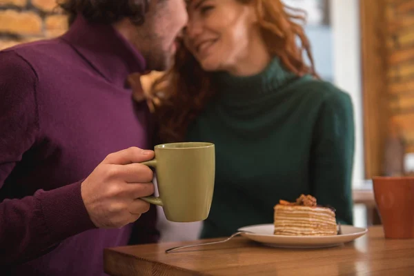 Glad ung man och kvinna dricka varm dryck i café — Stockfoto
