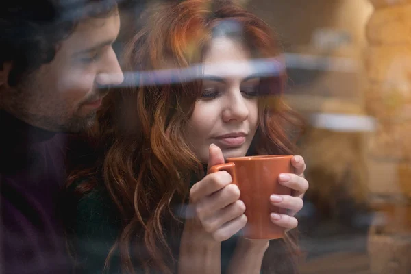 Happy loving couple drinking hot beverage indoors — Stock Photo, Image