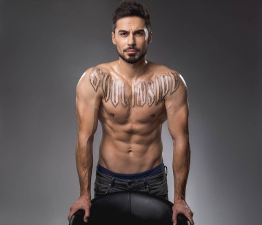 Attractive bodybuilder showing bare torso clipart