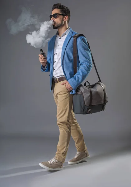 Young handsome relaxing man smoking on move — Stock Photo, Image