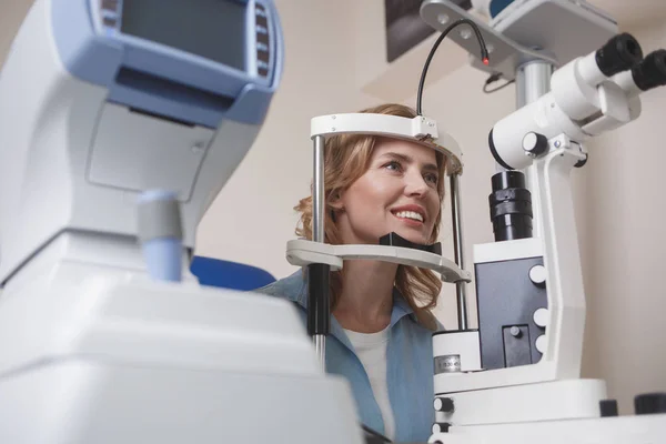 Happy woman examining in hospital — Stock Photo, Image