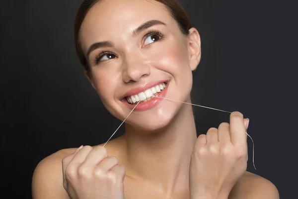 Pleased young woman is caring of oral health — Stock Photo, Image