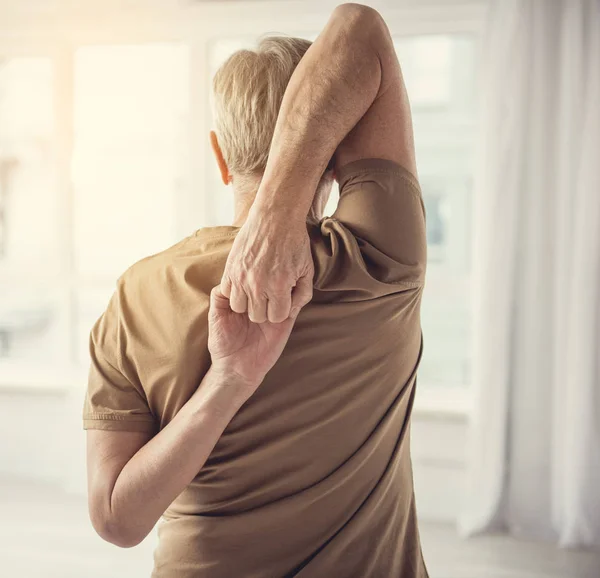 Aging man stretching oefening uitvoeren — Stockfoto