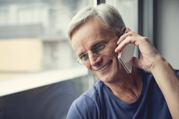 Mature man using telephone with joy — Stock Photo, Image