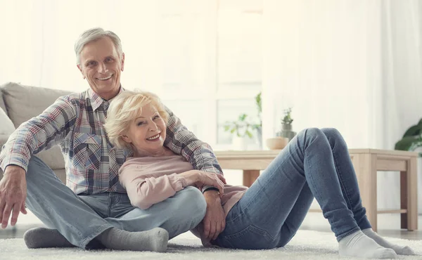 Personas mayores sonrientes descansando en el suelo — Foto de Stock