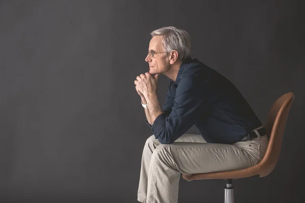 Pensive mature male locating on seat — Stock Photo, Image