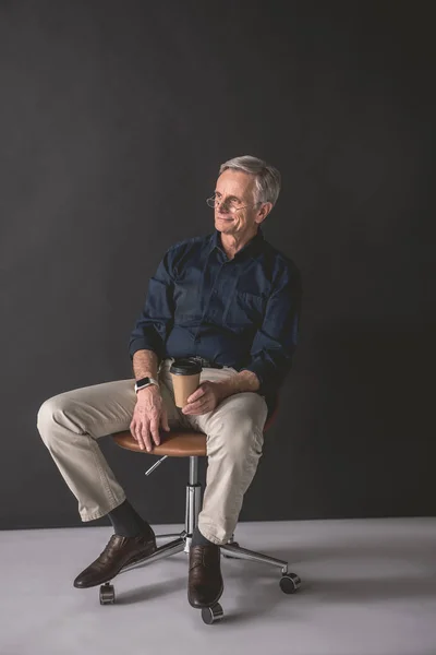 Happy retire male tasting mug of beverage — Stock Photo, Image