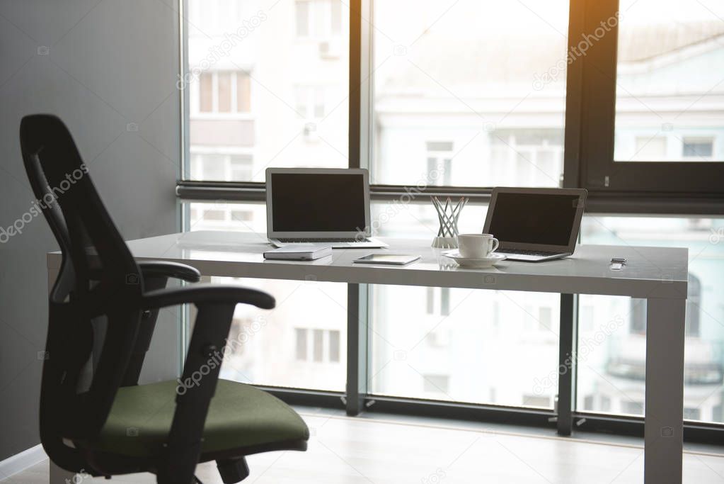 Laptops and workbook locating on desk