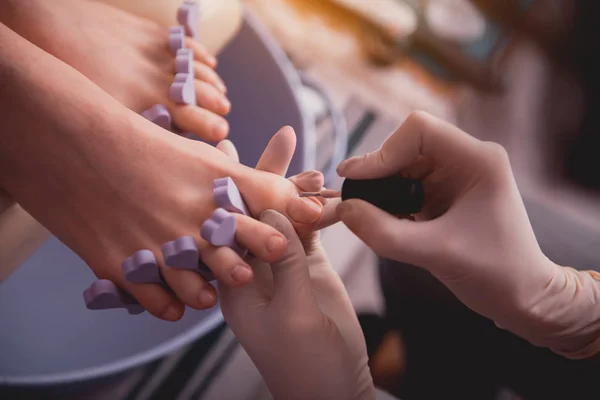 Жіноча рука наносить лак для нігтів для клієнта — стокове фото