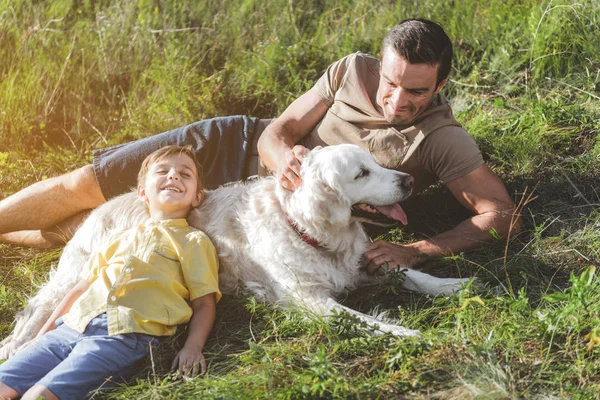 Carefree family playing with their pet — Stock Photo, Image