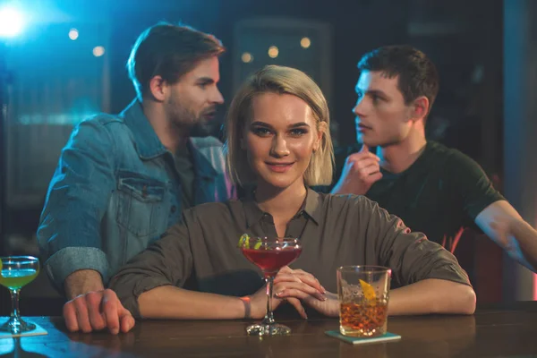 Cheerful female and men in bar