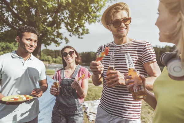 Friends enjoying barbecue and beer on open air — Stock Photo, Image