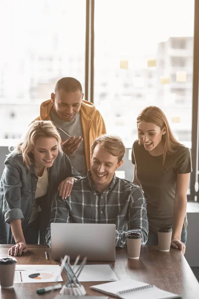 Office staff staring at gadget with interest — Stock Photo, Image