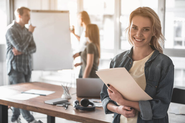 Smiling woman working with her team