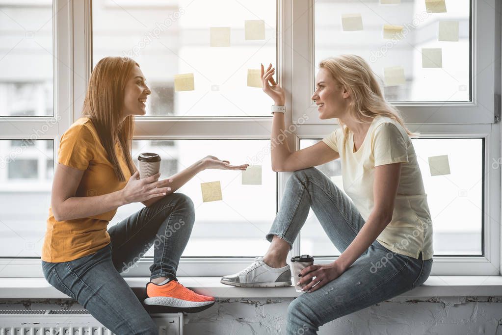 Office workers gossiping during coffee pause