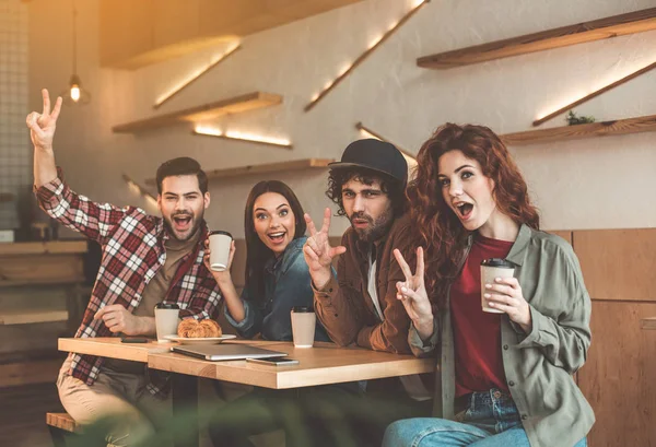 Happy young men and women gesturing positively — Stock Photo, Image