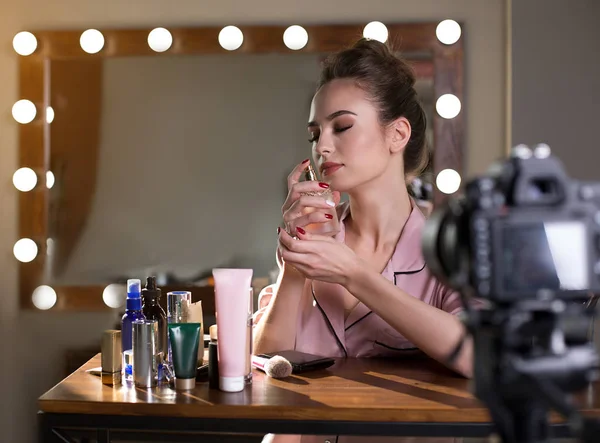 Charming girl is enjoying smell of her toilet water — Stock Photo, Image