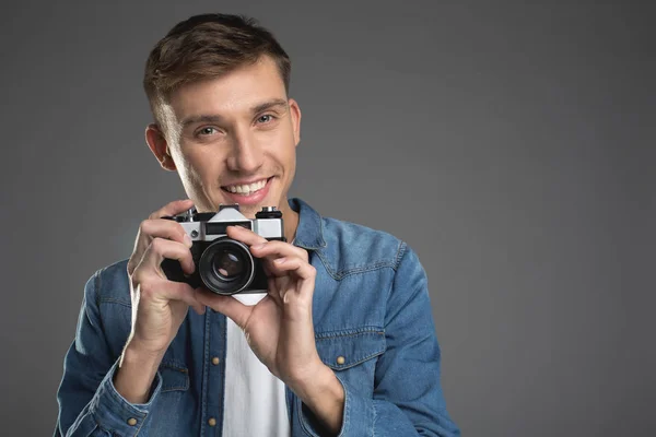 Enjoyed male person taking photo — Stock Photo, Image