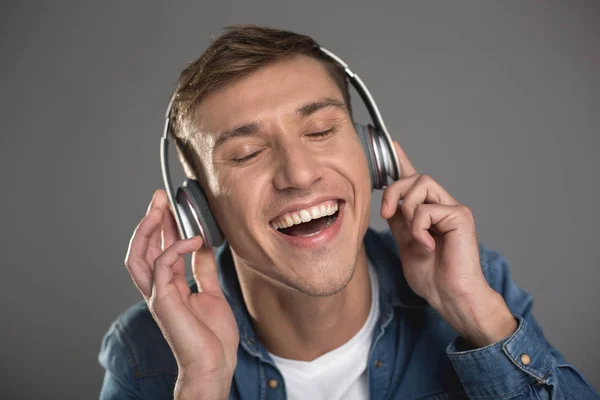 Happy man enjoying pleasant melody — Stock Photo, Image