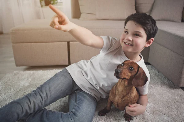 Dreamful child having fun with his puppy — Stock Photo, Image