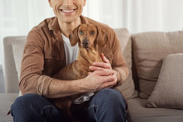 Hombre alegre sosteniendo cachorro en las manos — Foto de Stock