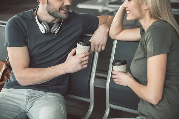 Beaming friends tasting mugs of beverage — Stock Photo, Image