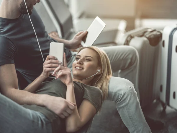 Pareja feliz descansando en el aeropuerto — Foto de Stock