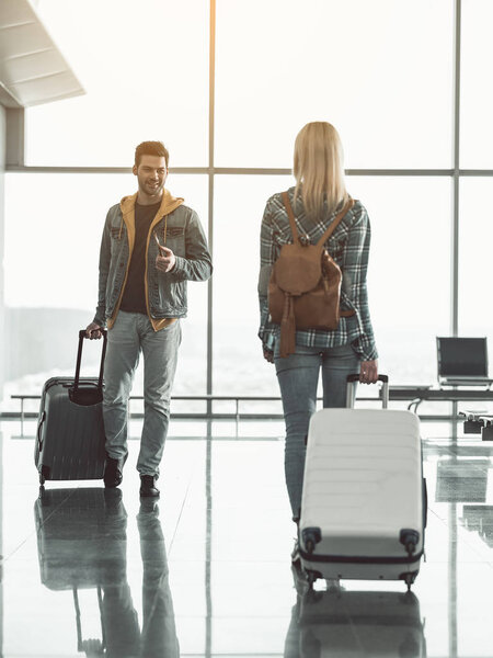 Outgoing male speaking with girl in terminal