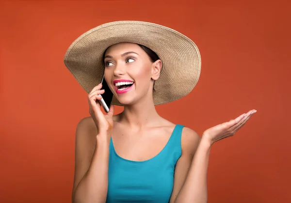 Mujer en sombrero disfrutando de la comunicación del teléfono celular — Foto de Stock