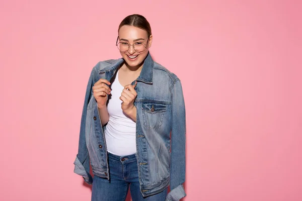 Fröhliche junge Frau posiert mit Jeansjacke — Stockfoto