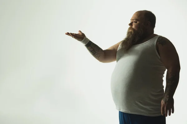 Promyšlené Tlustý chlap stál a ukazoval rukou — Stock fotografie