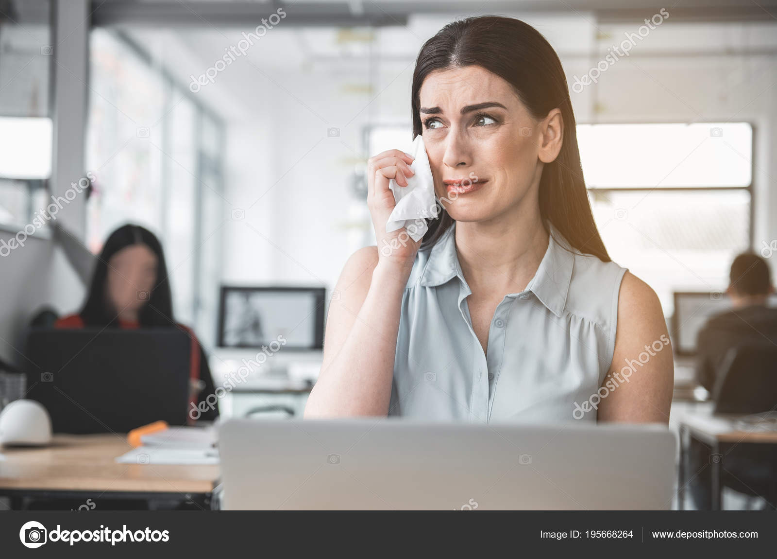 Crying female wiping away tears Stock Photo by ©iakovenko123 195668264
