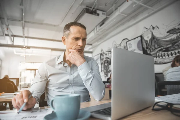 Pensive businessman watching at gadget — Stock Photo, Image