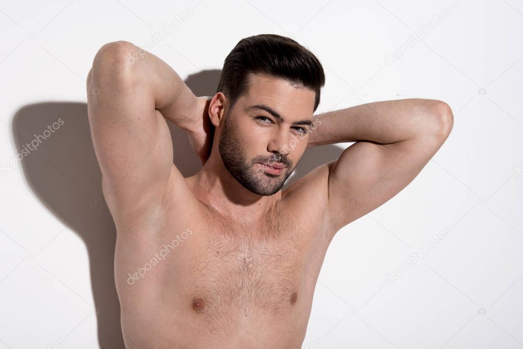 Attractive young man is enjoying his muscular body