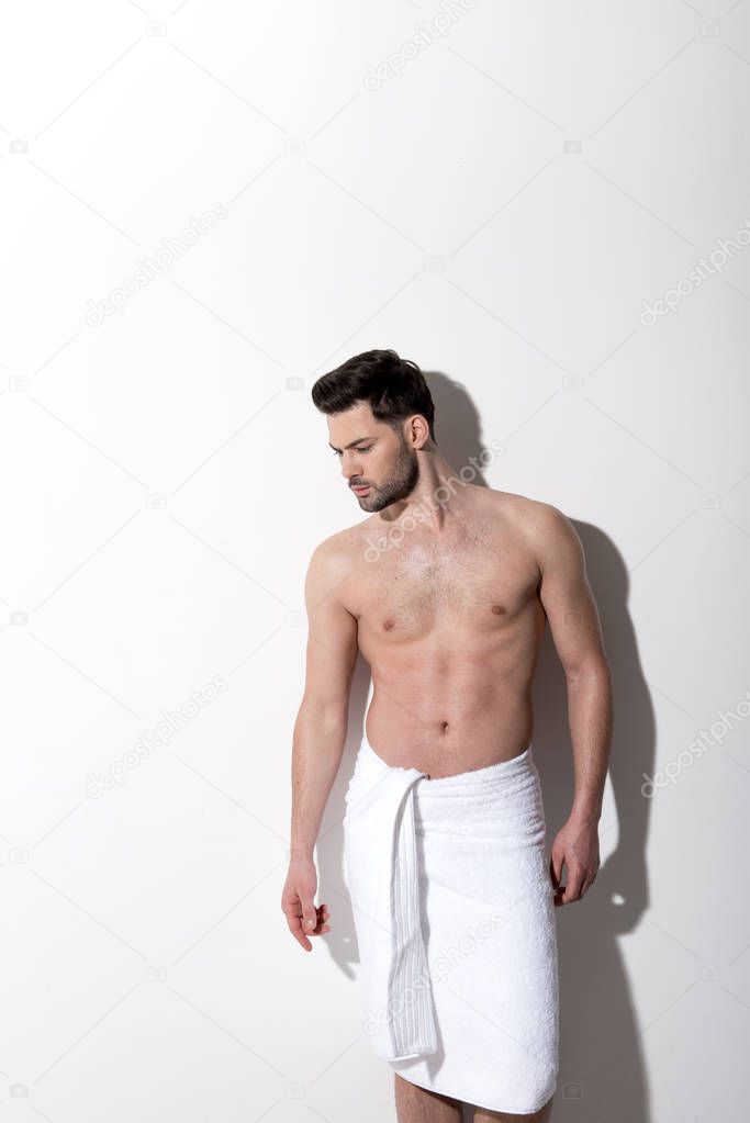 Serious guy is posing without clothes