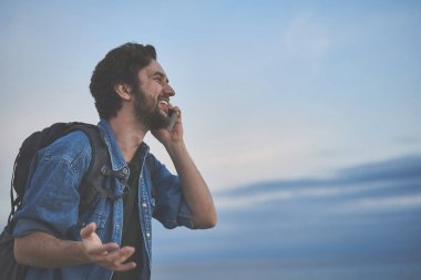 Neşeli erkek turistik sahil, cep telefonu tarafından konuşma