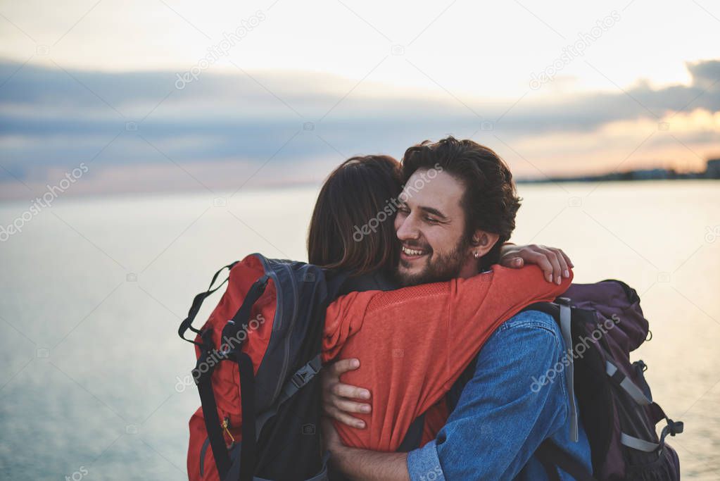 Happy man embracing woman at the seaside