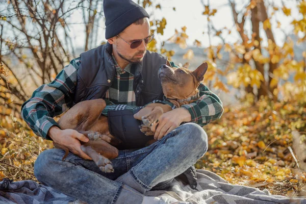Type homme apaisant le chien dans ses bras photo de stock — Photo