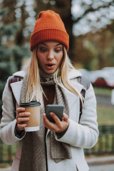 Bella donna con caffè guardando smartphone moderno — Foto Stock