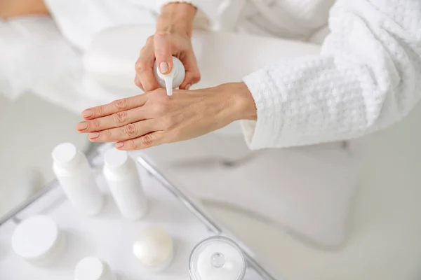 Close up of woman pressing cream on the hand — Stock Photo, Image