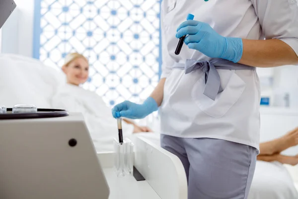 Woman watching the actions of a cosmetologist before the procedure — ストック写真