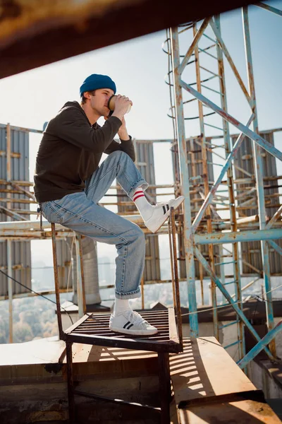 Young stylish male drinking coffee on the roof — Stock Photo, Image