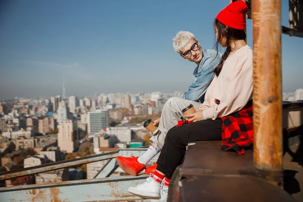 Young guy in glasses looking at girlfriend on roof — 스톡 사진