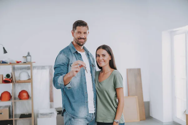 Felice uomo e donna con chiave nella nuova casa — Foto Stock