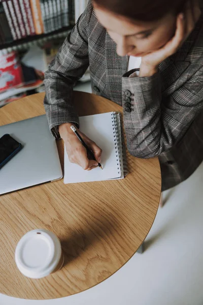 Thoughtful lady with notebook writing with pencil — 스톡 사진