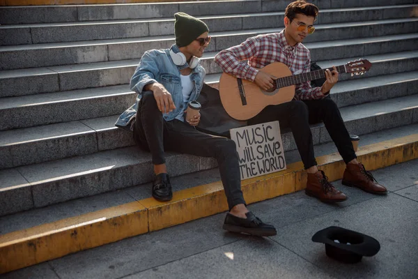 Músicos elegantes estão tocando guitarra na rua — Fotografia de Stock