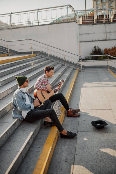 Young musicians singing songs on the street stairs