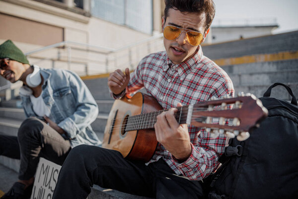 Stylish musician singing a song in the city