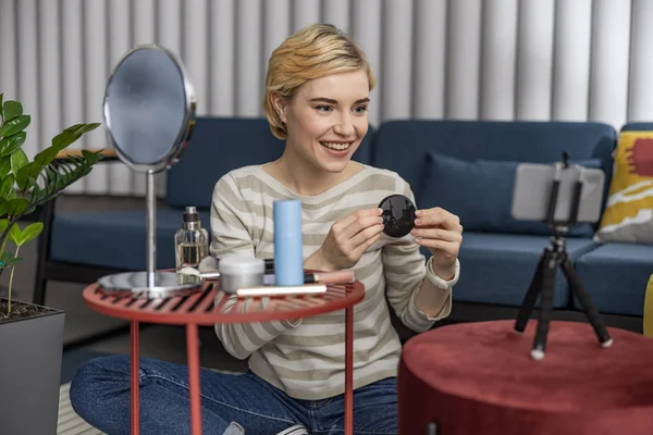 stock image Happy female blogger showing makeup on camera