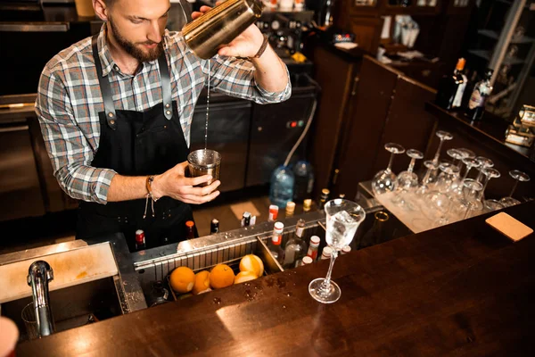 Bearded bartender is standing at bar counter — Stock Photo, Image